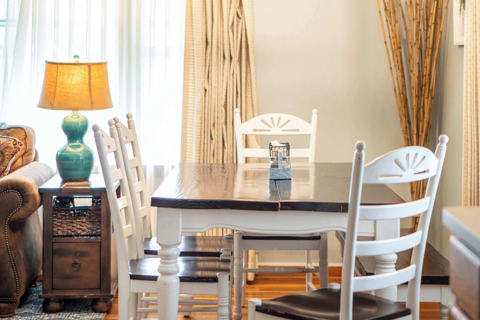 Dining room area seats four with natural lighting.