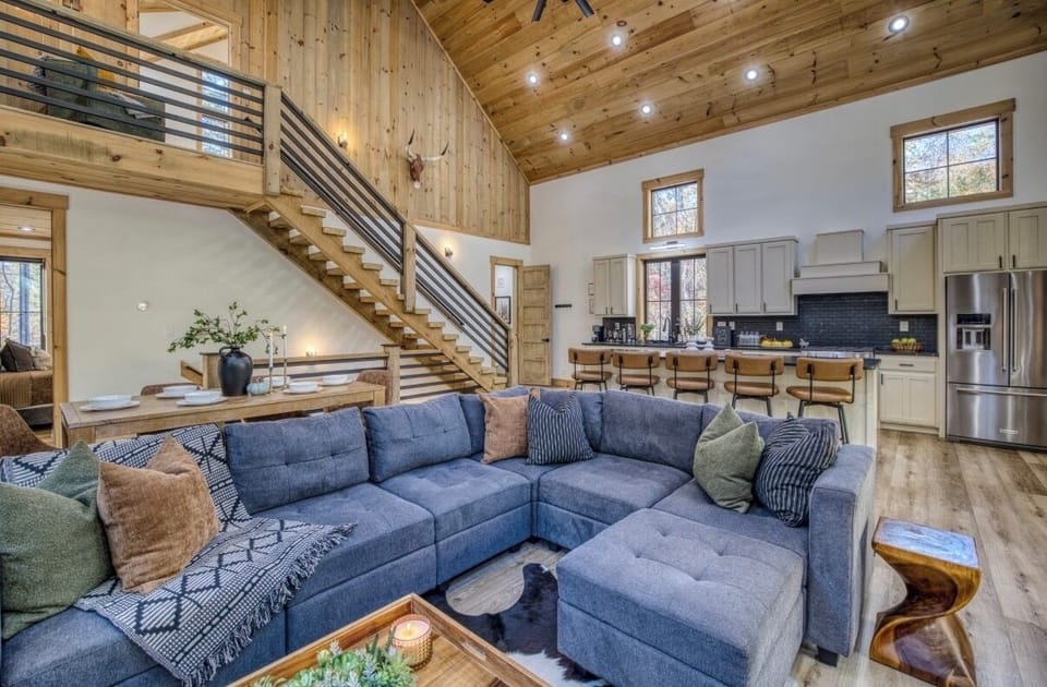 Bright, open living room with vaulted ceilings and a cozy sectional