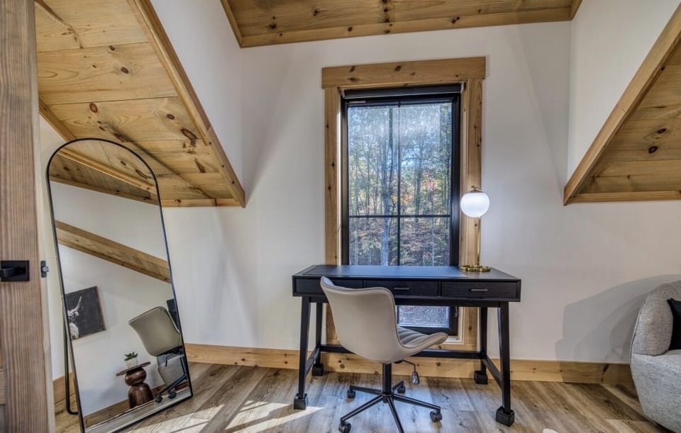 King suite with a private workspace and forest views