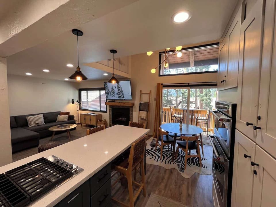 Living room dining area and private deck viewed from kitchen.