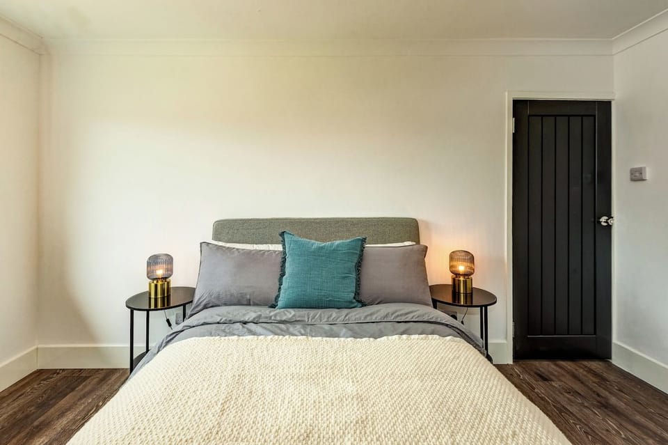 Spacious double bedroom with plenty of storage, including a chest of drawers, wardrobe, and extra cupboard for luggage. Blackout blinds ensure a restful night’s sleep
