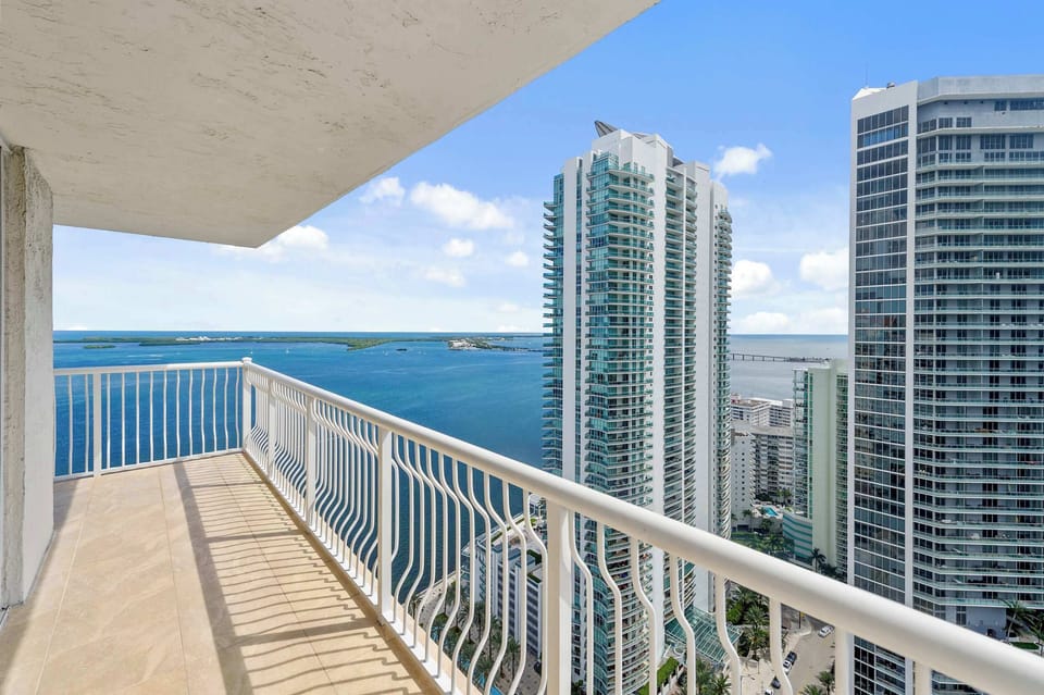 Step out onto the private balcony overlooking the city skyline.