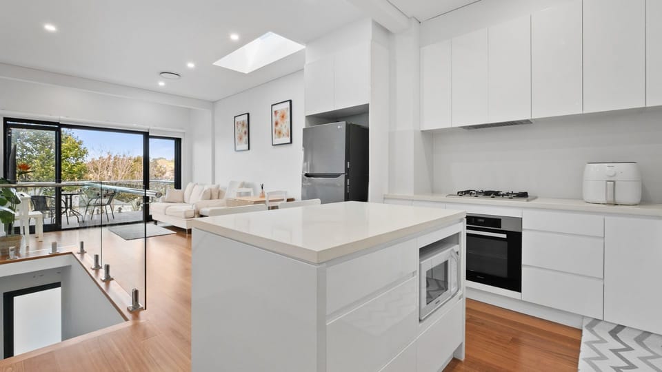 Step into contemporary elegance with this stunning open-plan kitchen and living area, perfect for entertaining.