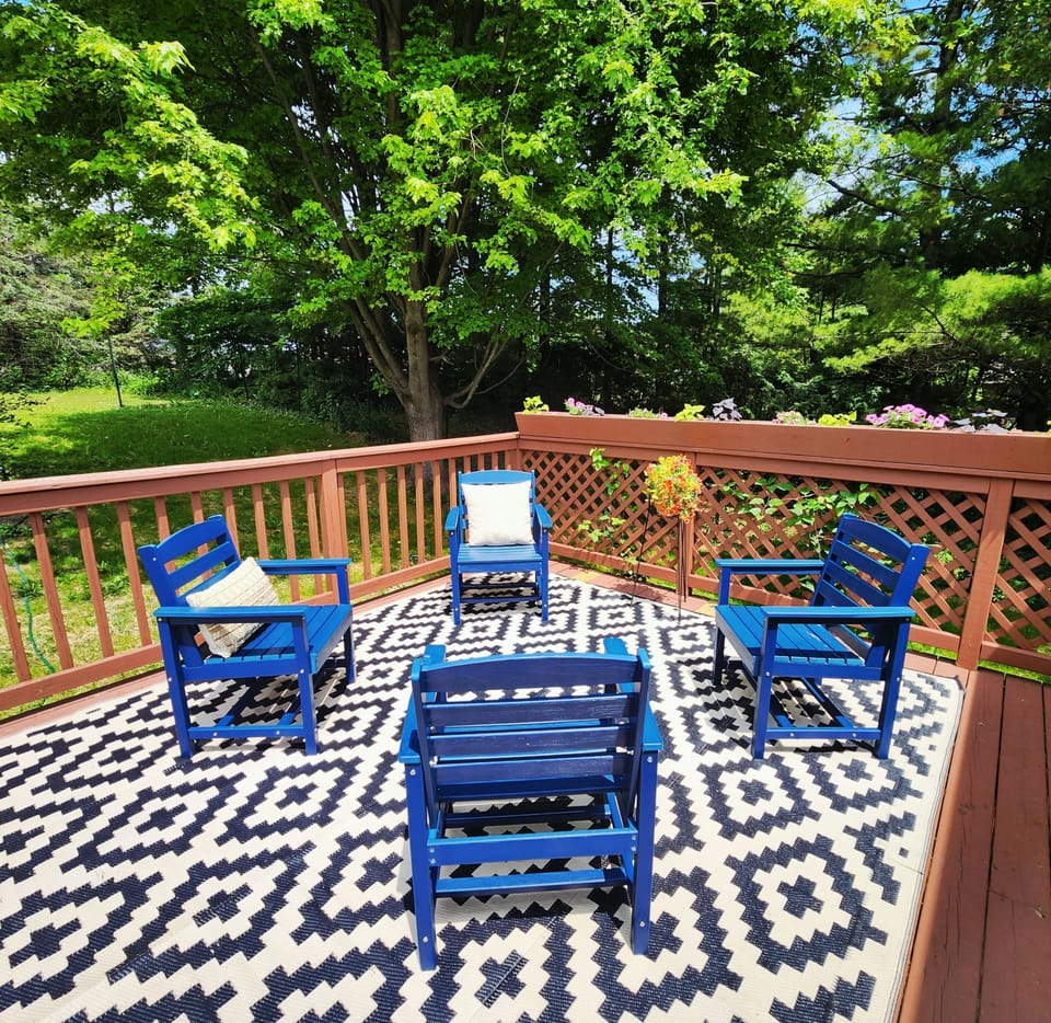 Deck with outdoor seating and gas grill.