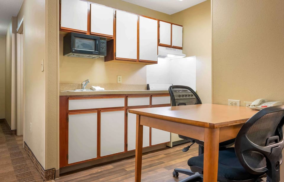 Desk, laptop workspace, blackout drapes, iron/ironing board