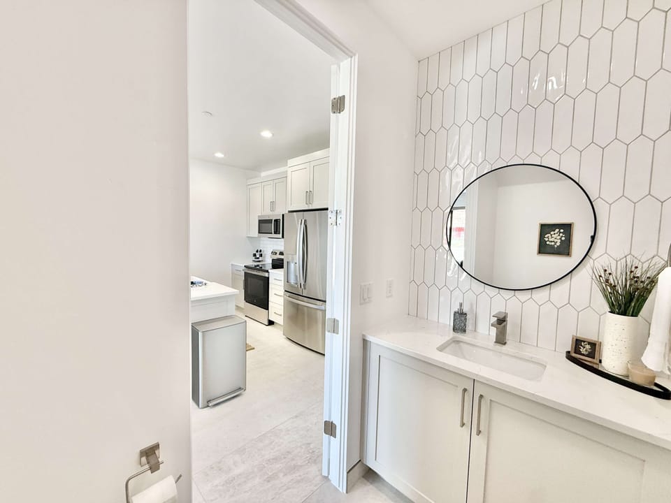 Convenient powder room just off the kitchen — modern tile details and thoughtful touches for your comfort
