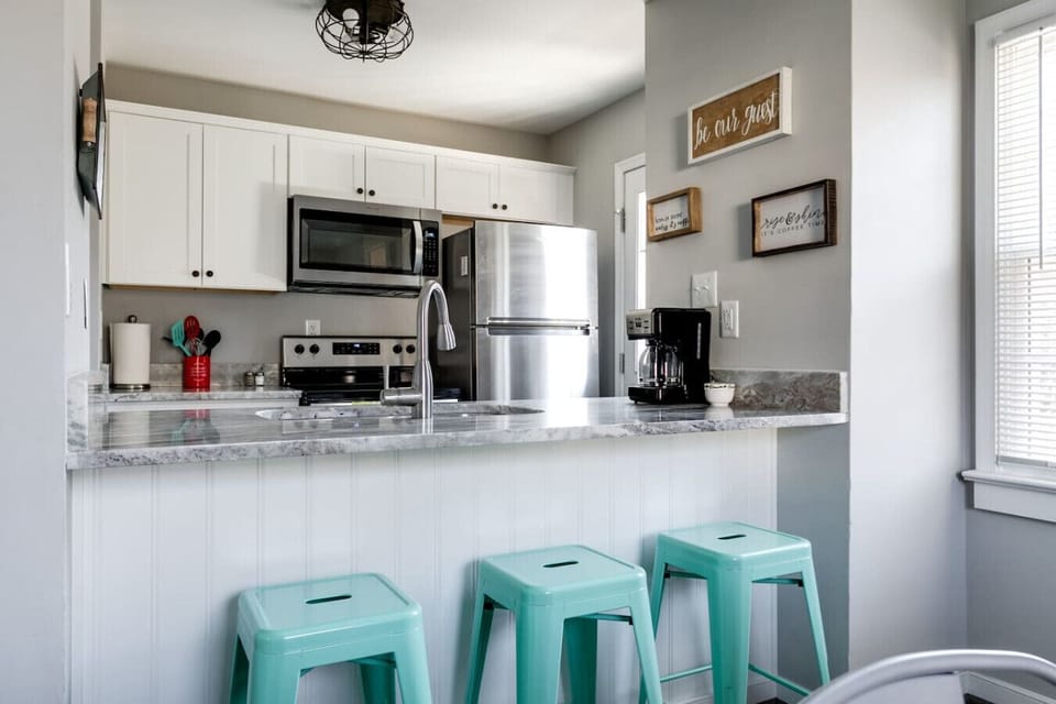 Whip up meals with ease in this fully stocked kitchen featuring a double basin sink, stove, microwave, dishwasher, and fridge. Bar seating and coffee essentials (Keurig + drip maker) make it both functional and inviting!