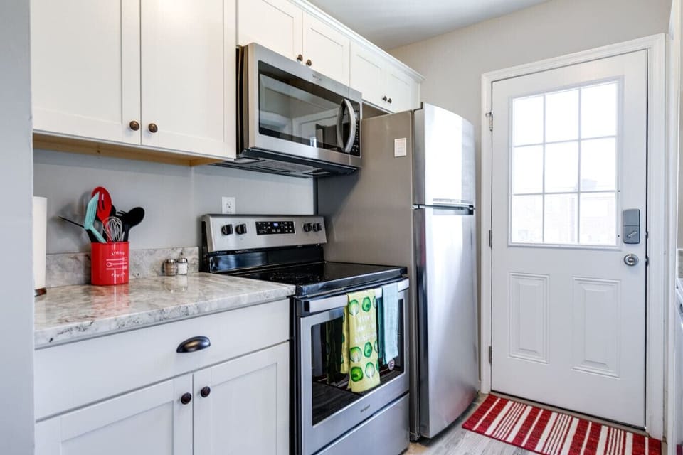 Whip up meals with ease in this fully stocked kitchen featuring a double basin sink, stove, microwave, dishwasher, and fridge. Bar seating and coffee essentials (Keurig + drip maker) make it both functional and inviting!