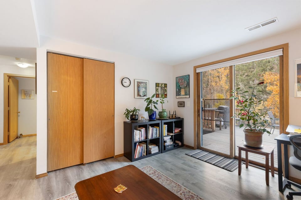 bottom floor living area w/ futon and outdoor access