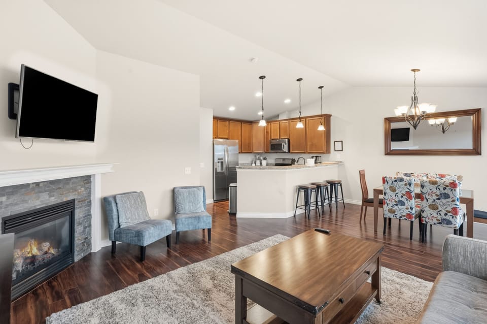 Open floor plan is enhanced by views and fireplace for cozy, easy entertaining