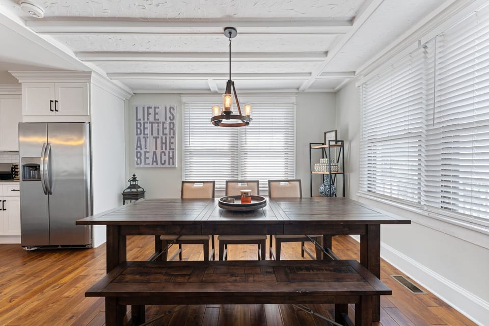 Enjoy meals together in the charming, coastal-inspired dining area. This rustic yet modern space features a large wooden table with seating for the whole group, perfect for memorable gatherings.