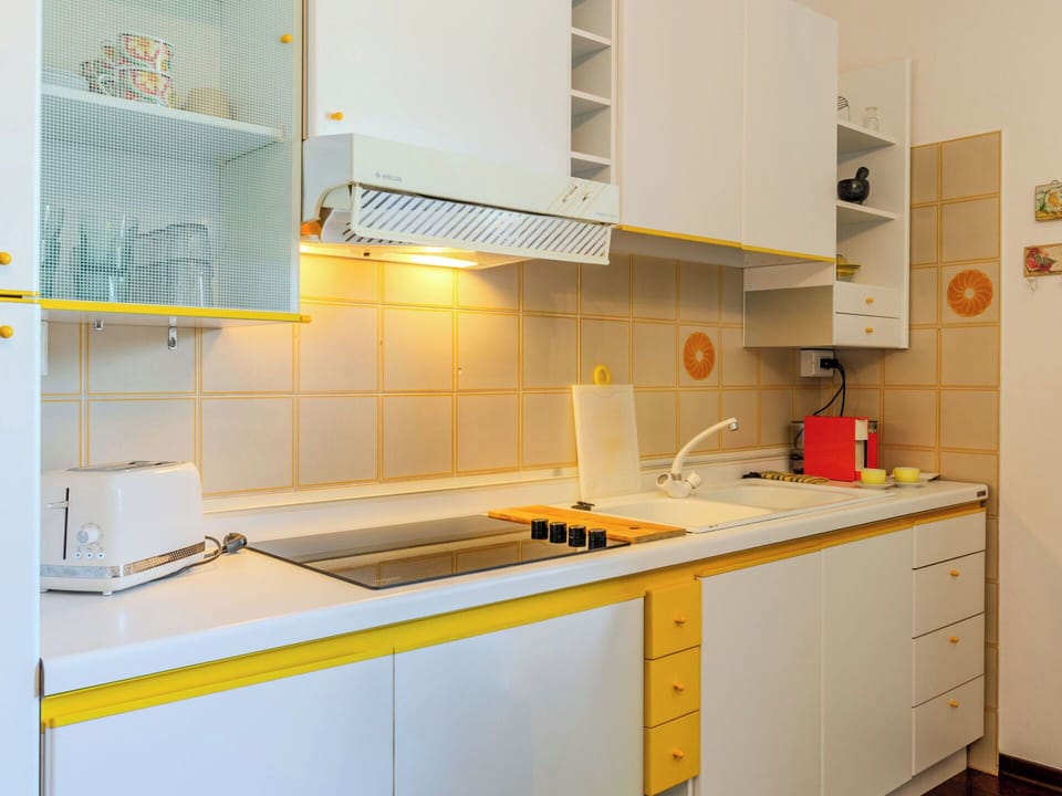 Kitchen, Countertop, Yellow, Interior Design, Kitchen Appliance, Flooring, Cabinetry, Major Appliance, Room, Furniture