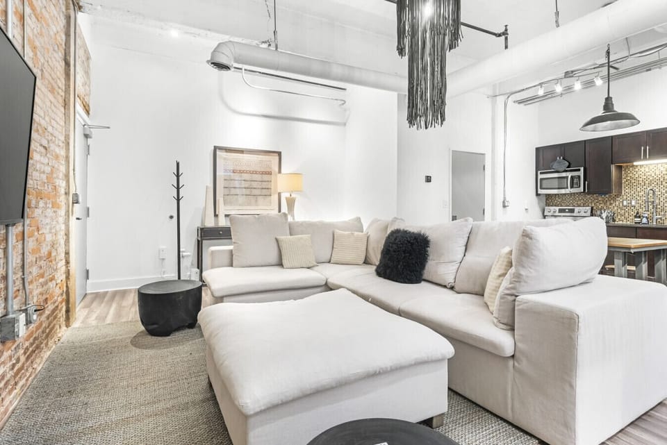 White and black living room with comfy sectional couch