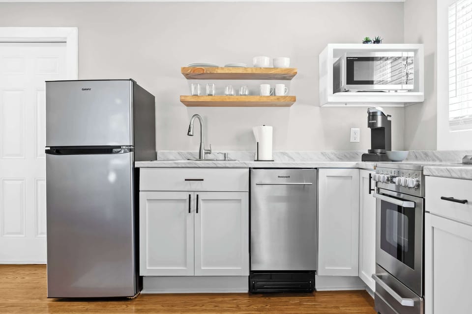 Kitchen: Whip up your favorite meals in this fully equipped kitchen — where modern amenities meet homey charm for a seamless cooking experience.