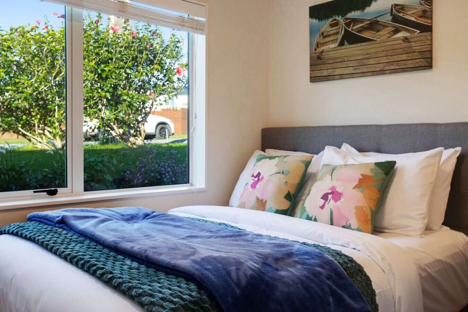 The flower cushions match the throw and brings the outside in.