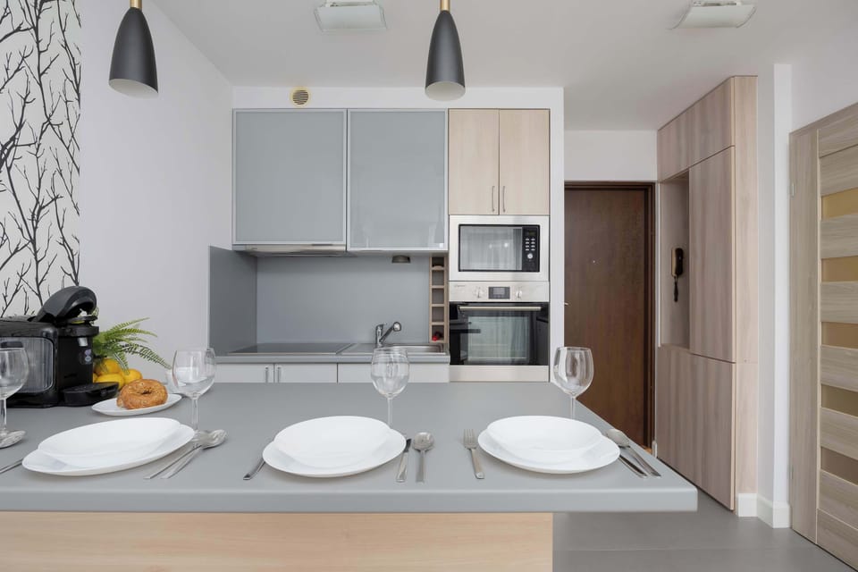 Dining area and fully equipped kitchenette with electric cooktop, oven, electric kettle, refrigerator with freezer, microwave and dishwasher.