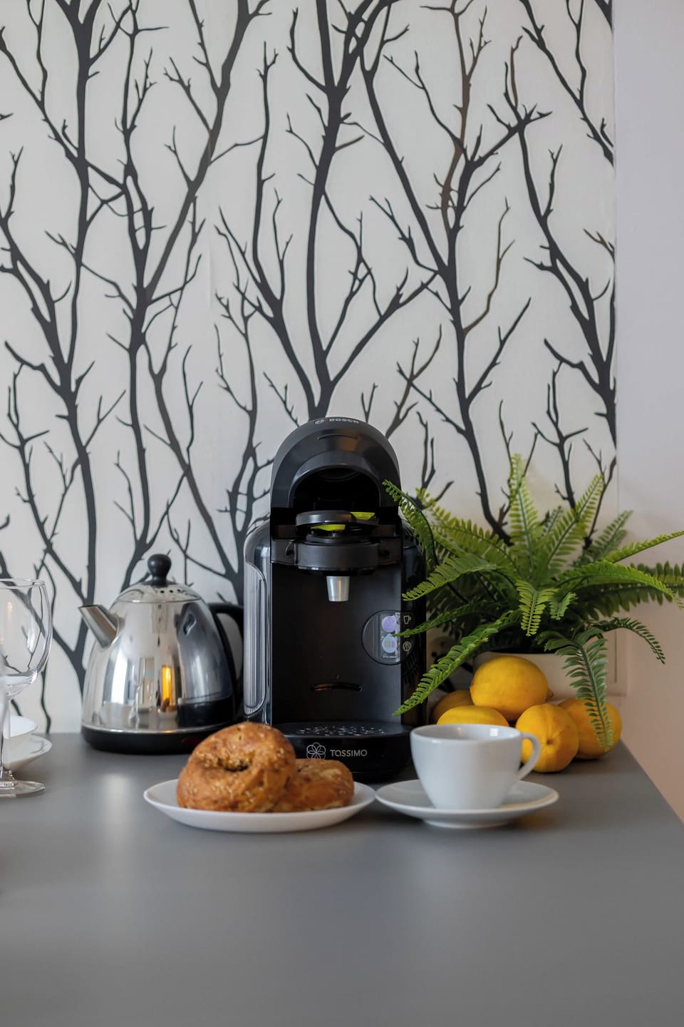 Kitchen island with coffee maker and kettle.