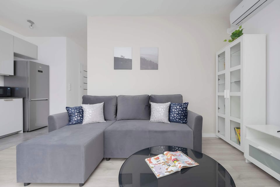 Another angle of the living room with a slightly different perspective, highlighting its open and airy design with white walls and neutral tones.