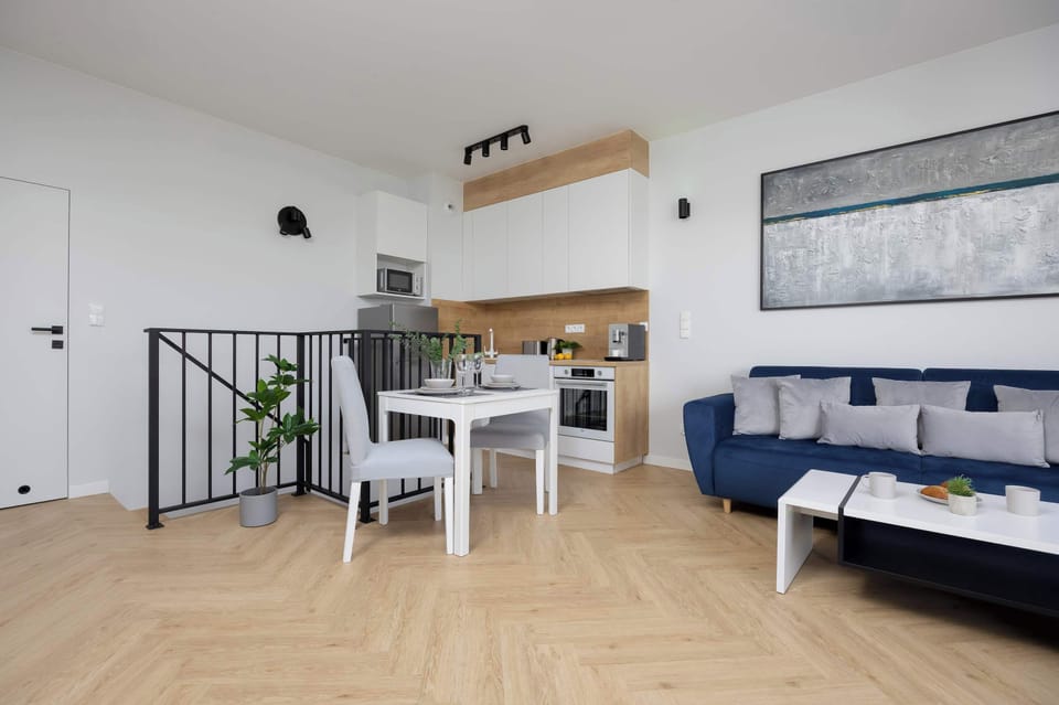 The spacious living room combined with the dining area and access to the balcony offers a comfortable and stylish space for relaxation and gatherings.