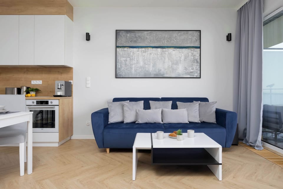 The spacious kitchenette combined with the living room in light colors provides a comfortable and harmonious living space.