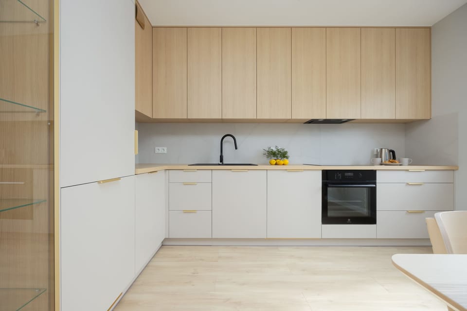 A modern kitchen with light cabinetry and an L-shaped layout offers ease for everyday cooking.