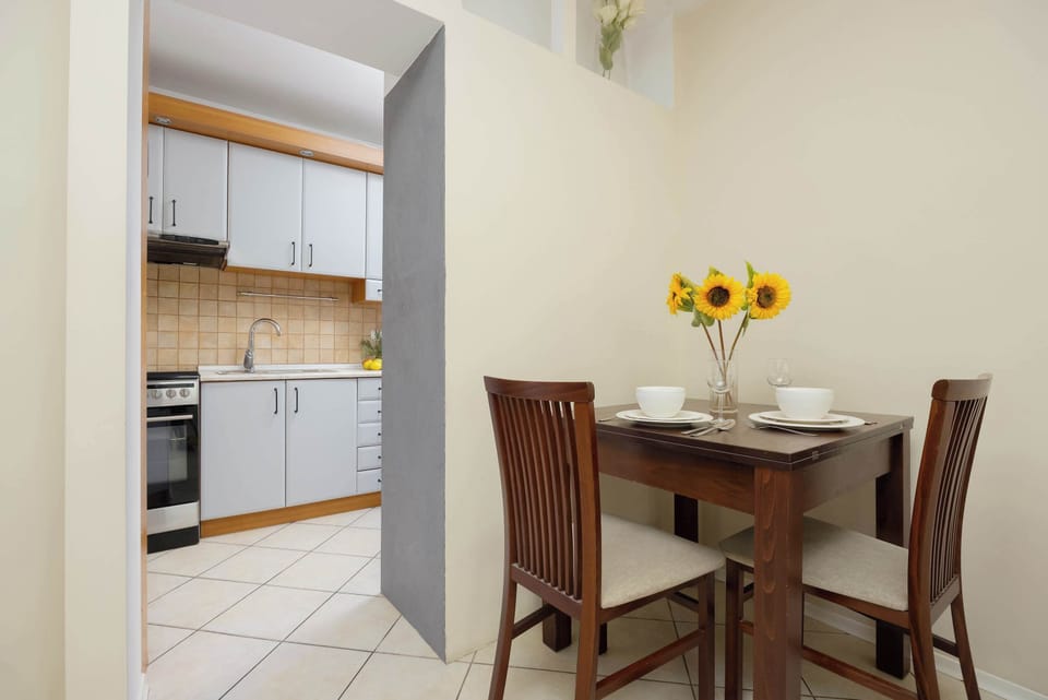 A cozy dining table with decorative sunflowers is perfect for enjoying a morning coffee for two.