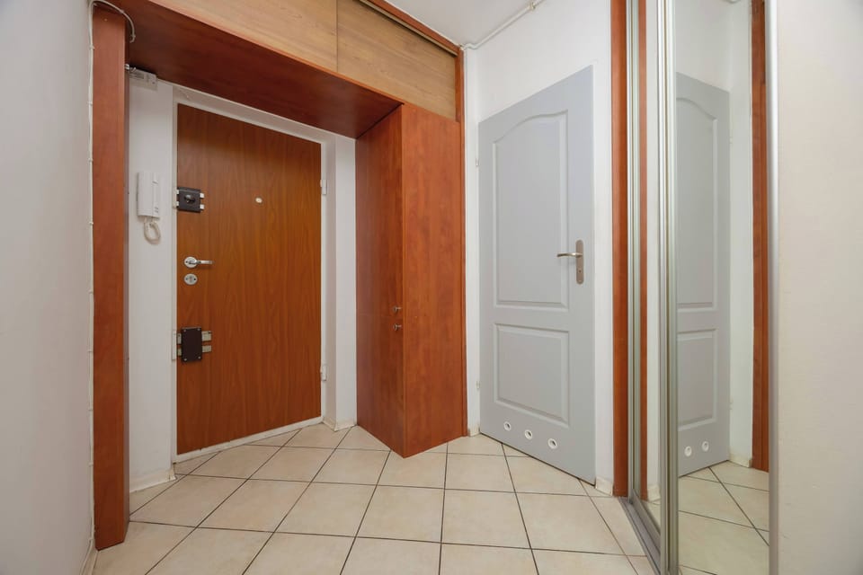 A spacious hallway with a large mirror makes it easy to get ready before heading out.