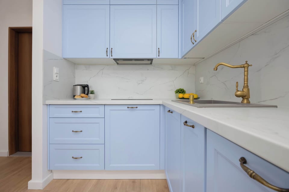A golden faucet and marble countertop bring a luxurious and stylish touch to the interior.