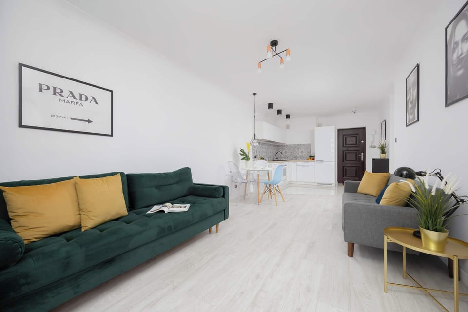 View of the entire living room and kitchenette, with plenty of bright space for guests.