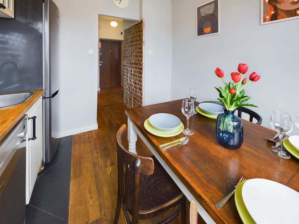 A comfortable kitchen area with a dining table where you can enjoy meals together.
