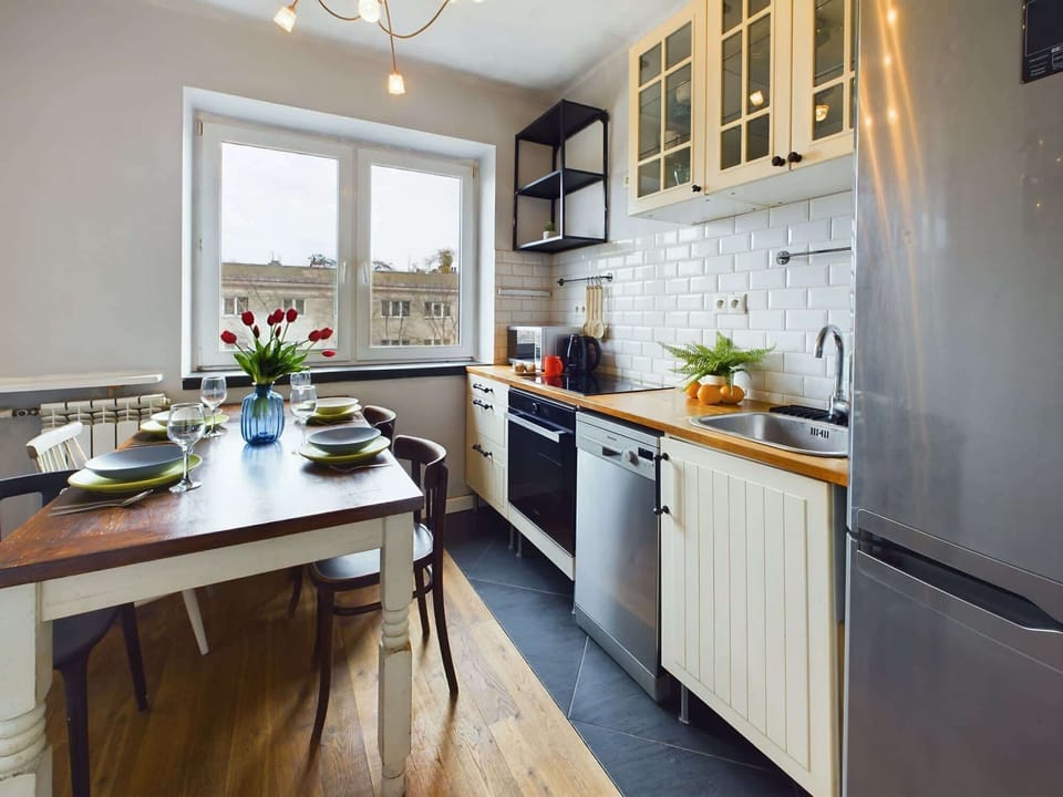 The functional kitchen with a wooden dining table has been decorated with all guests' needs in mind.