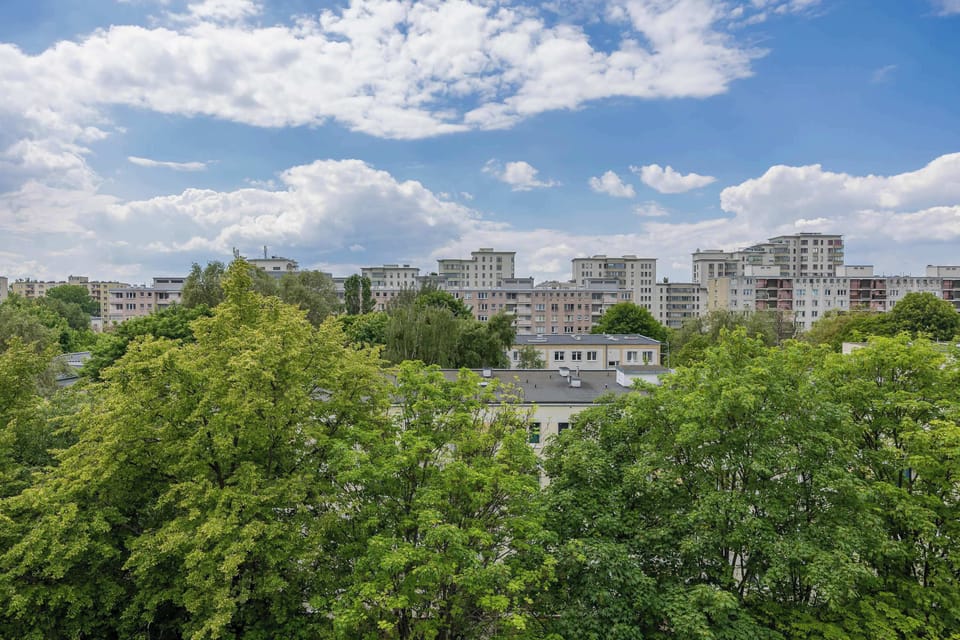 A second view of the same cityscape, showing treetops and multiple high-rise buildings.