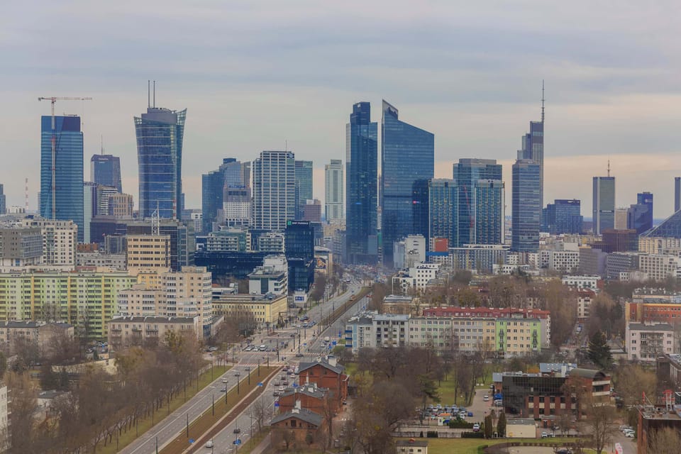 A wide-angle view of the city skyline with a mix of modern skyscrapers and urban greenery.