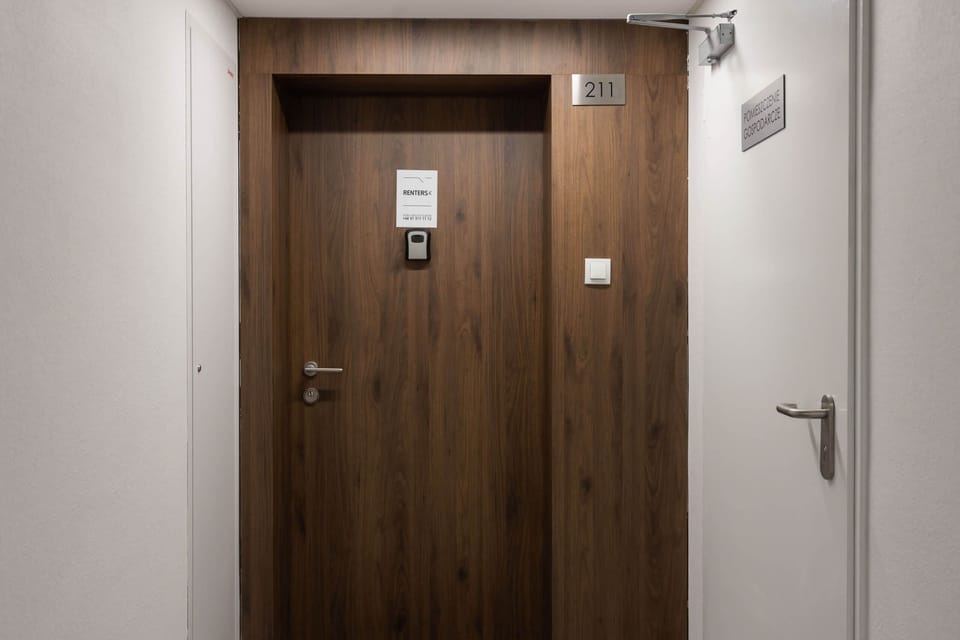Apartment door with secure locking and minimalist design, ensuring privacy and safety during your stay.
