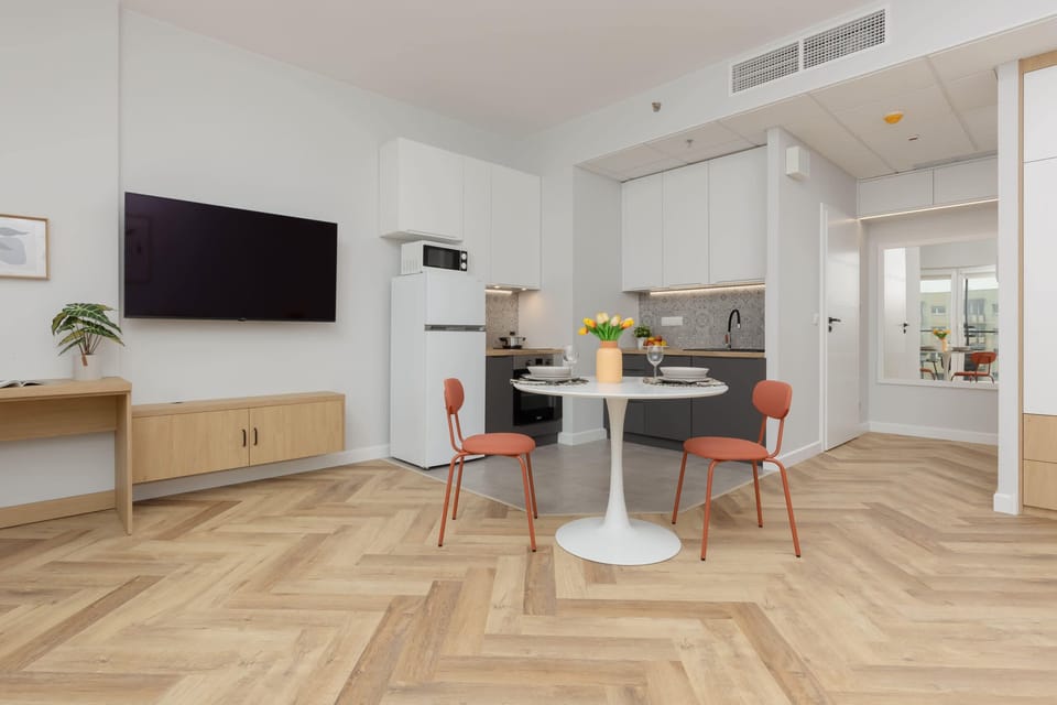 Open-concept living room with elegant furniture, a flat-screen TV, and plenty of space for relaxation or entertainment.
