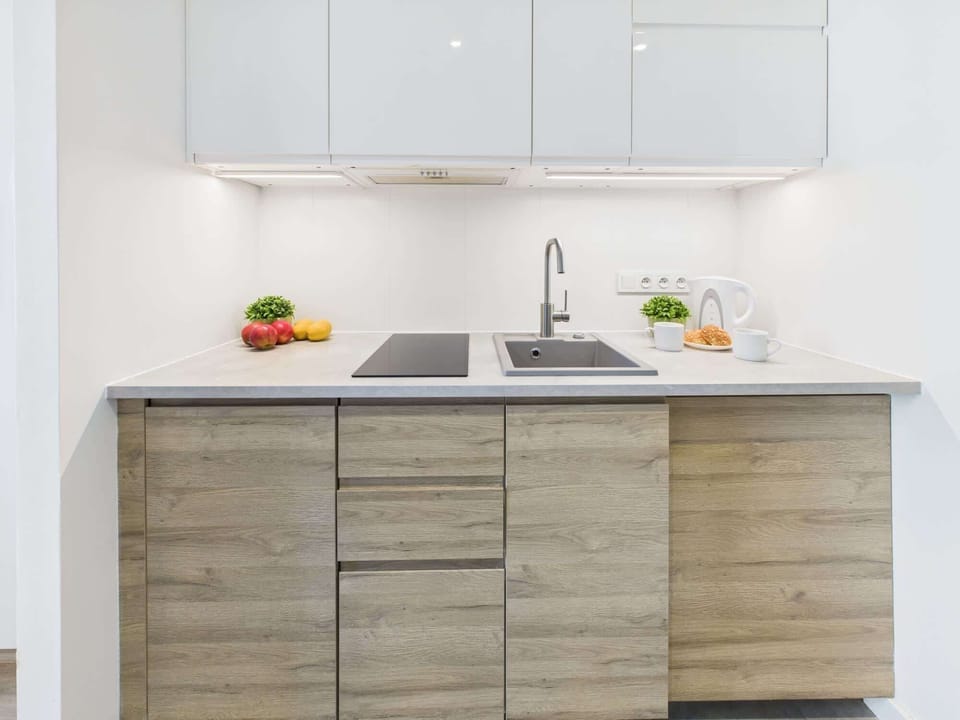 Kitchenette with plenty of kitchen utensils and dishes. 