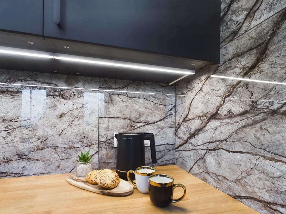 Close-up of the kitchen countertop with a coffee maker and fruit decor.