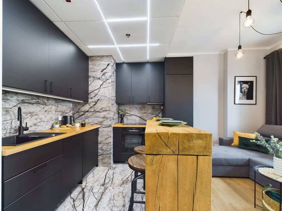 Open-concept space with a living room flowing into a sleek kitchen area.