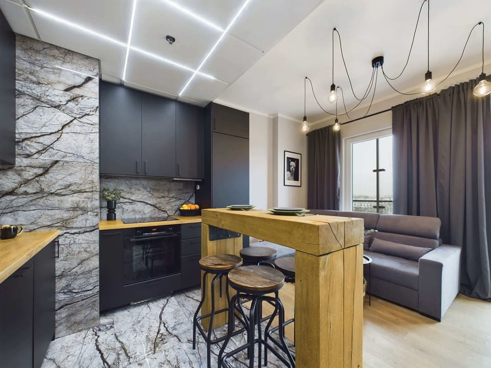 Open-concept space with a living room flowing into a sleek kitchen area.