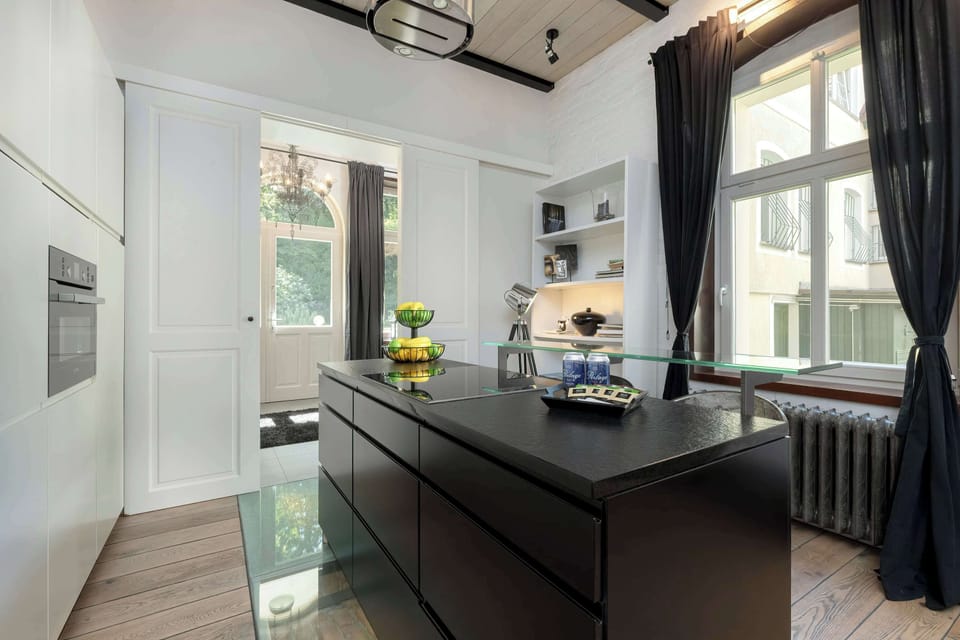 A sleek kitchen island with a stone countertop and built-in storage. Doubles as a breakfast bar.