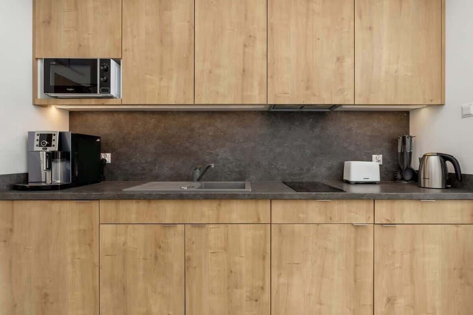 A detailed view of the kitchen workspace, showing a coffee machine and modern appliances. Everything you need within reach.