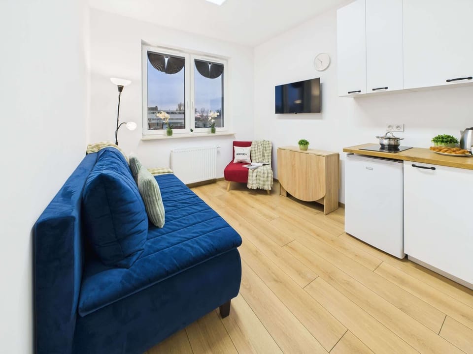 A detailed shot of a blue sofa captures the living space’s cozy atmosphere. The seating area adds warmth and elegance to the interior.