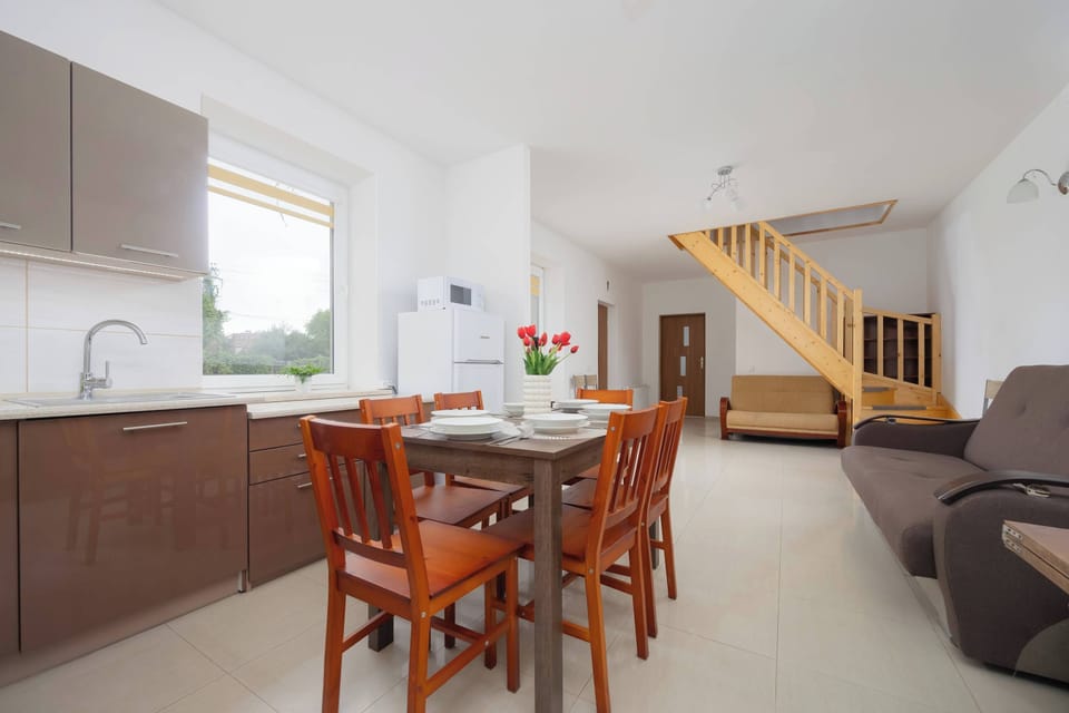 Kitchenette with customised furniture with white goods. Microwave oven and fridge with freezer. Dining table for 6 persons. 