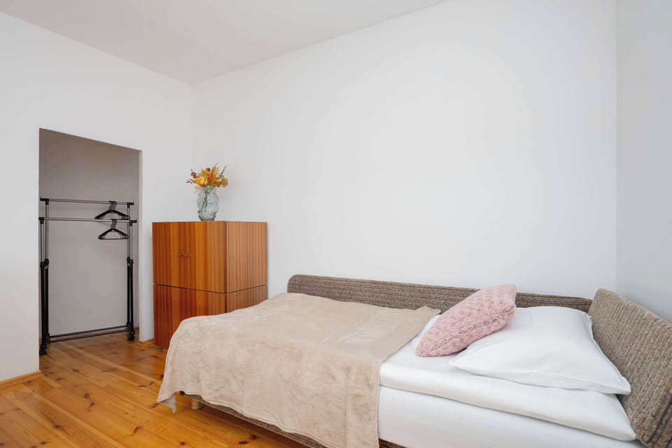 First floor bedroom for up to 3 people. The bedroom has a double sofa bed and a single sofa bed. There are cupboards and a wardrobe in the room. 