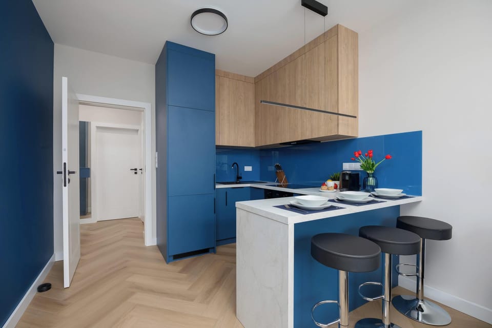 Kitchenette with oven and refrigerator. 