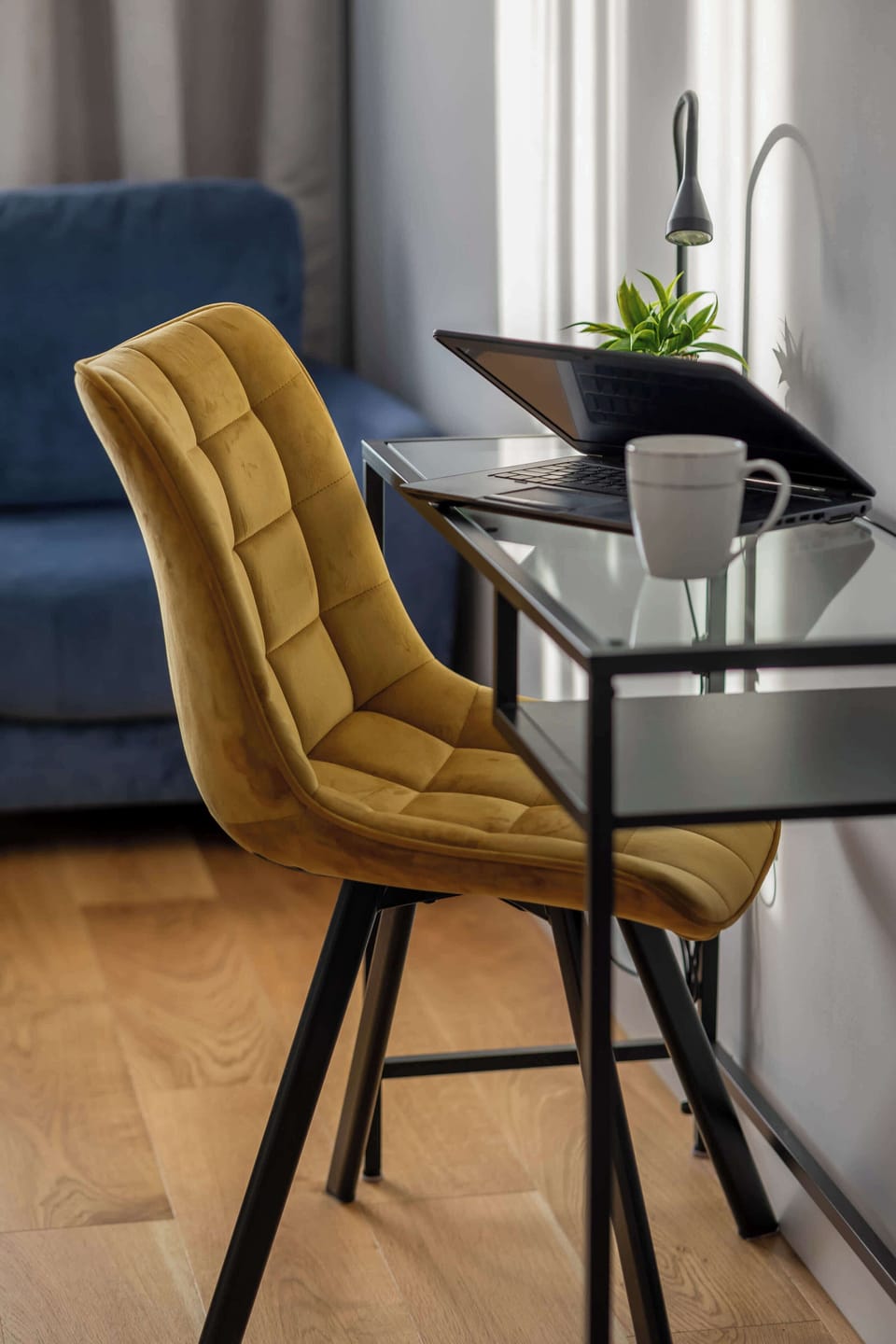 A small desk area with a bright yellow chair, perfect for working or studying.