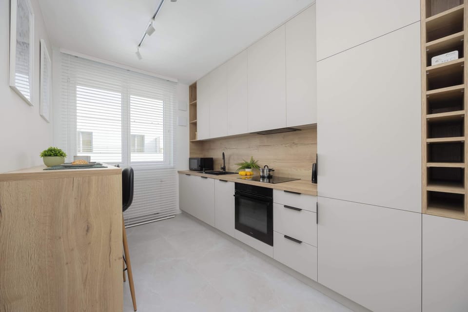 A modern kitchen fitted with sleek cabinetry and warm lighting blends function with aesthetics.

