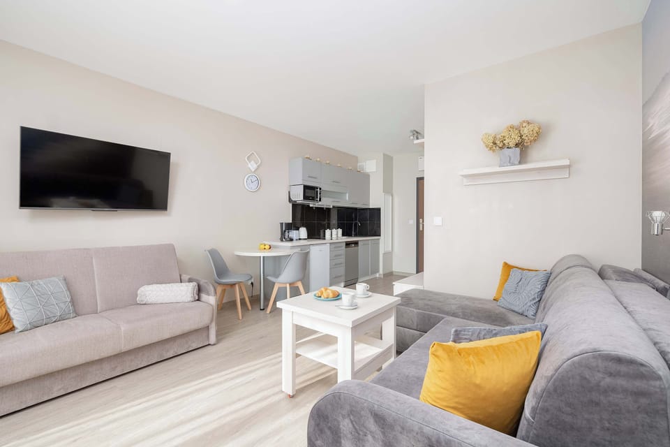 A side table next to the sofa, decorated with a small lamp and minimalistic décor.