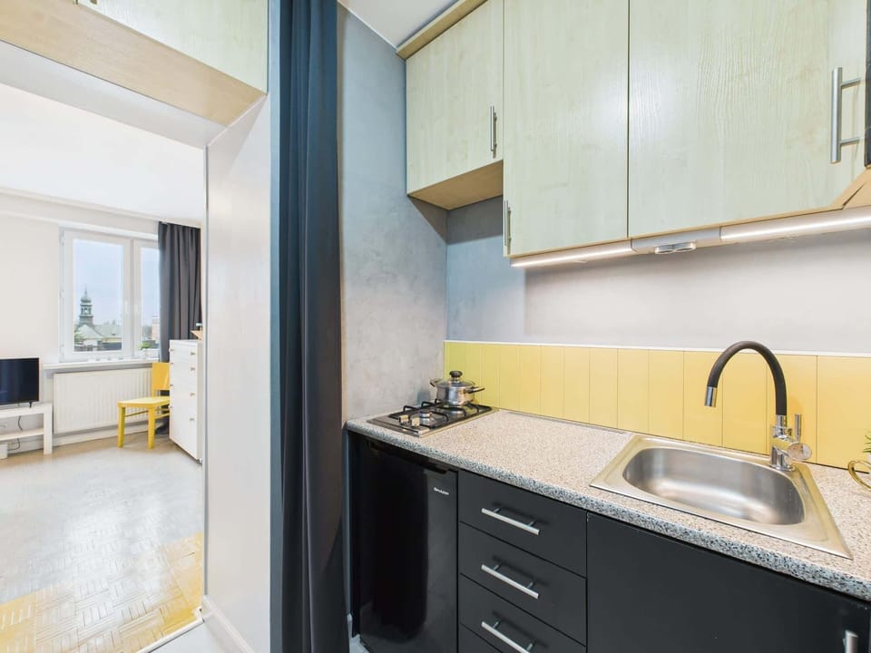 A different perspective of the kitchen, showing the connection between the cooking area and the sleeping space.
