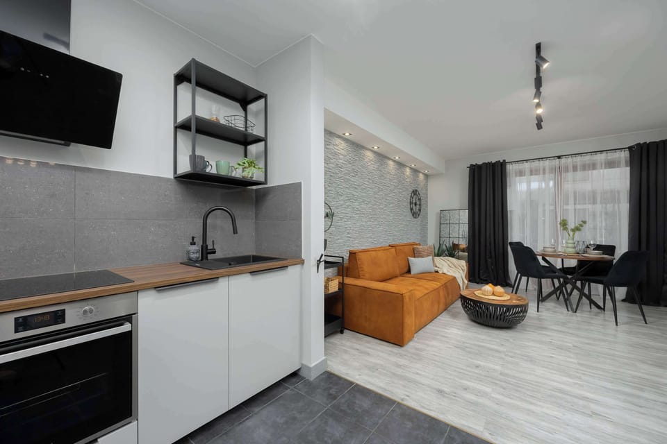 A different angle of the kitchen, showing its open layout and connection to the dining area. The decor is minimalistic yet elegant.